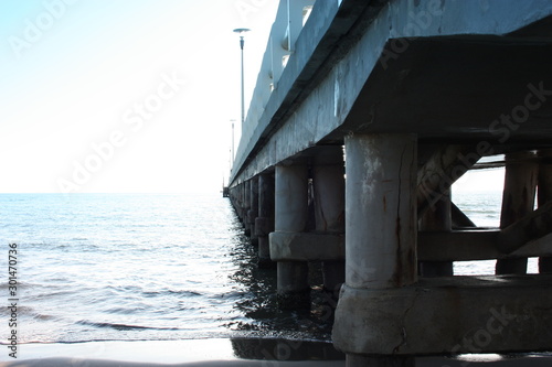 pylons bearing a pier on the sea © Alessia