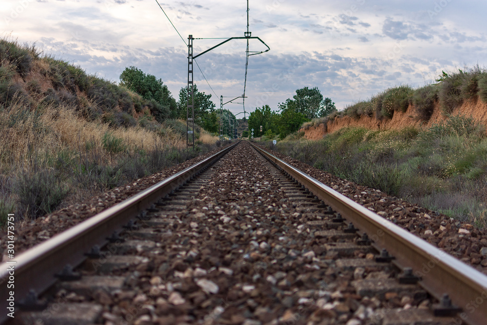 Unique railroad line at the sunset. Train railway track . Low clouds over the railroad. Unique railroad line at the sunset. Train railway track . Low clouds over the railroad.