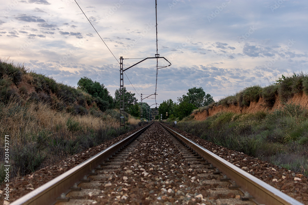 Unique railroad line at the sunset. Train railway track . Low clouds over the railroad.