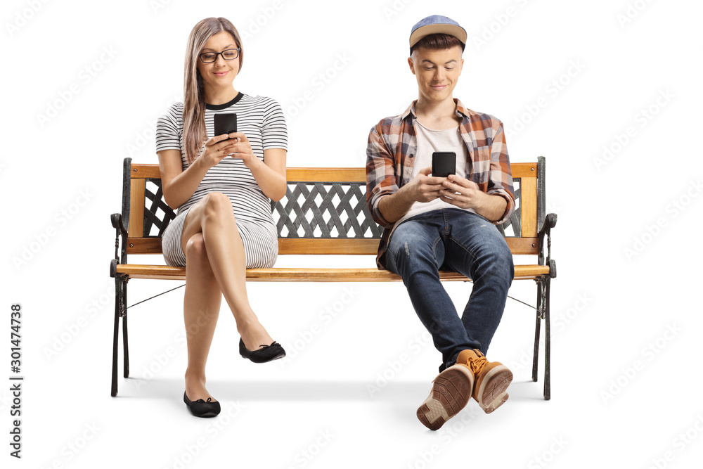 Φωτογραφία Young woman and a teenager sitting on a bench with mobile phones