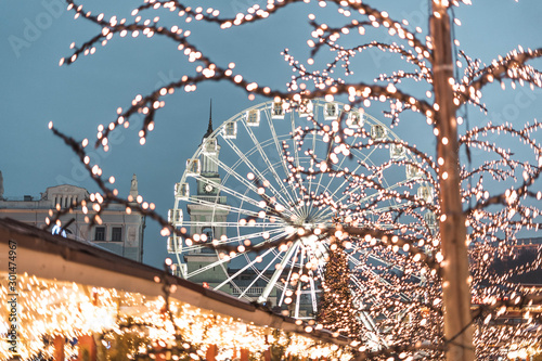 Night city street before Christmas snowy winter Ferris wheel photo