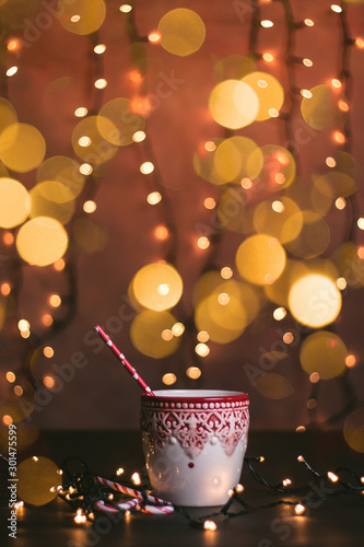 Holiday Christmas mug with red holiday straw and bokeh lights