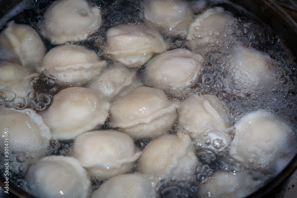 Dumplings in boiling water. Meat dumplings are boiled in a pot of boiling water.