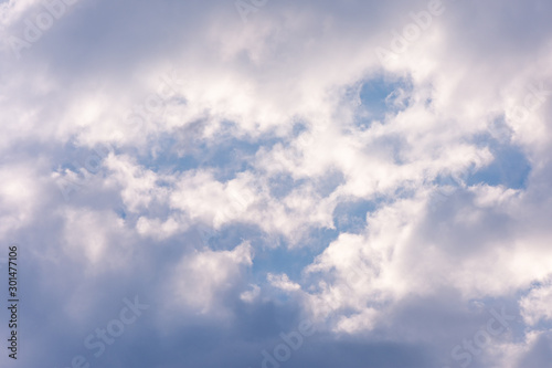 landscape sky with blue clouds and sunbeams at sunset. Background texture