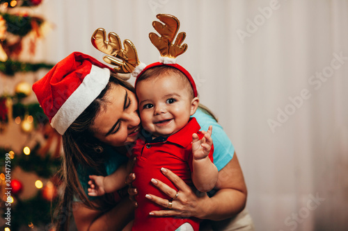 Mother and her baby playing at home on Christmas holiday