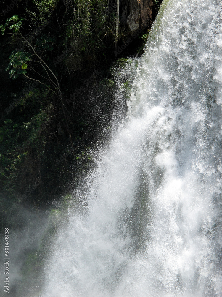 Iguazu Falls. A waterfall is an area where water flows over a vertical drop or a series of steep drops in the course of a stream or river iguazu Iguazu Falls. A waterfall is an area where water flows over a vertical drop or a series of steep drops in the course of a stream or river iguazu