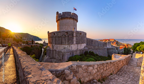 Old city walls with sight on Minceta Tower and Old Harbour of Dubrovnik at sunrise in Dubrovnik, Croatia photo