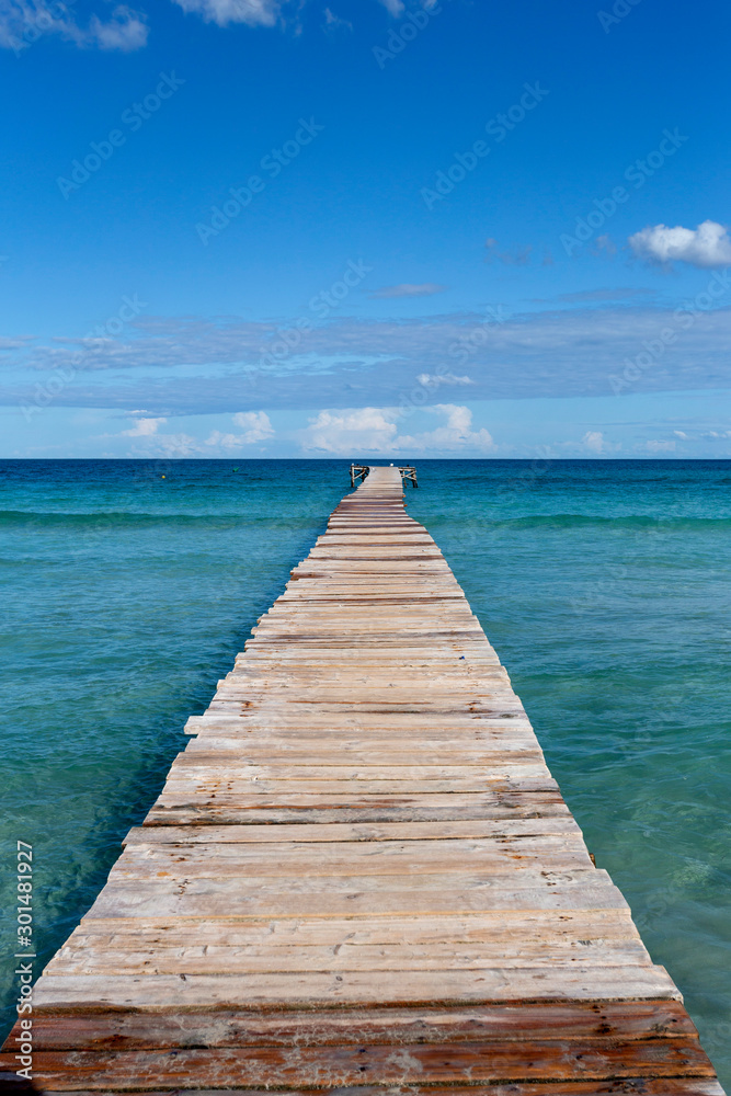 A wooden pier at Playa de Muro beach in Mallorca