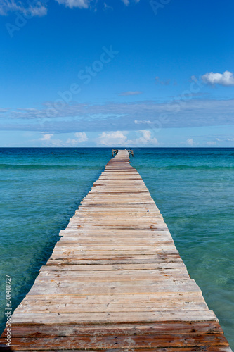 A wooden pier at Playa de Muro beach in Mallorca