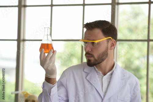 Scientists are working in science labs.Close-up of a scientistYoung female scientist looking through a microscope in a laboratory doing research photo