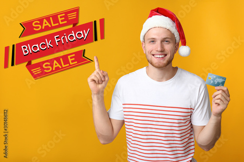 Happy young man in Santa ha...