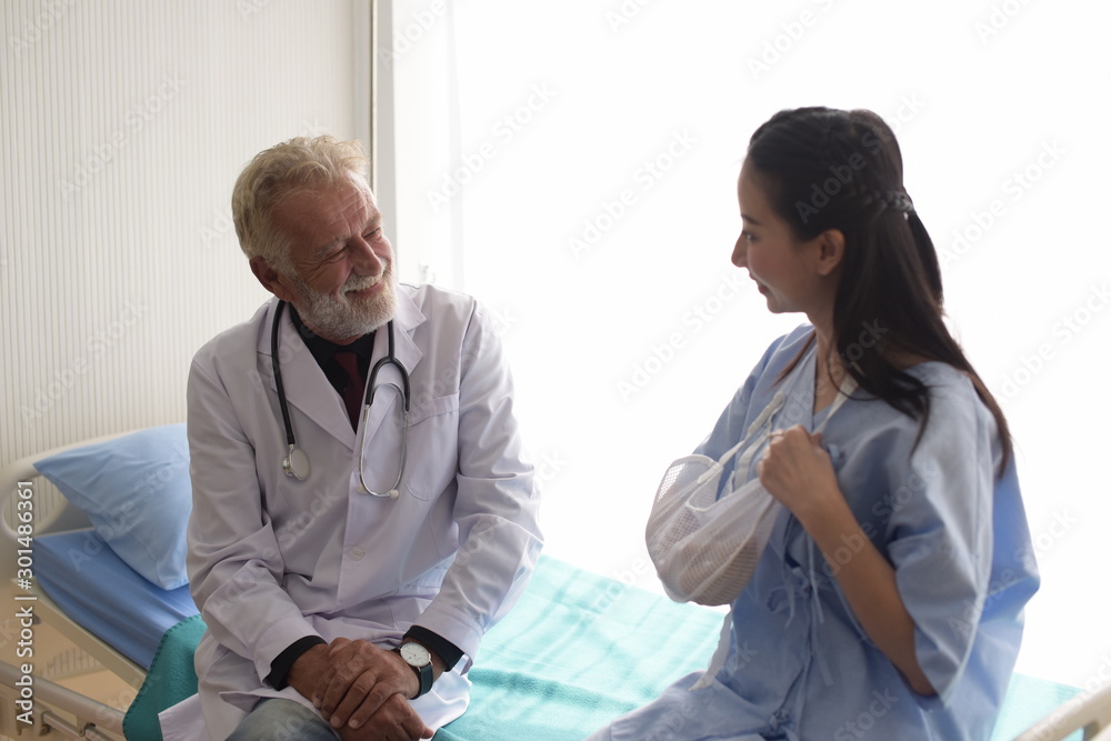 Fototapeta premium The doctor is taking care of the patient and checking the body and talking to the patient at the hospital.