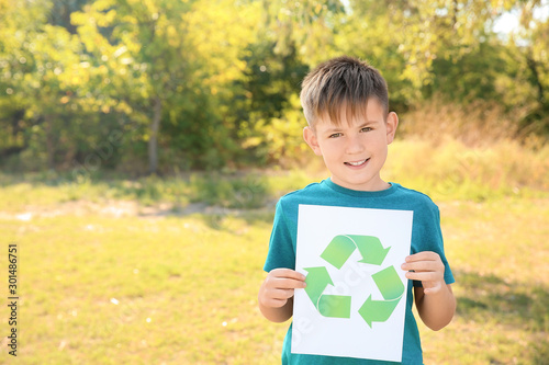 Boy holding paper sheet wit...
