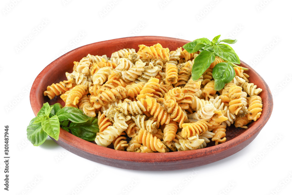 Plate with tasty pasta and pesto sauce on white background Plate with tasty pasta and pesto sauce on white background