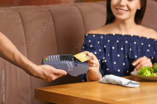 Woman paying bill in restau...