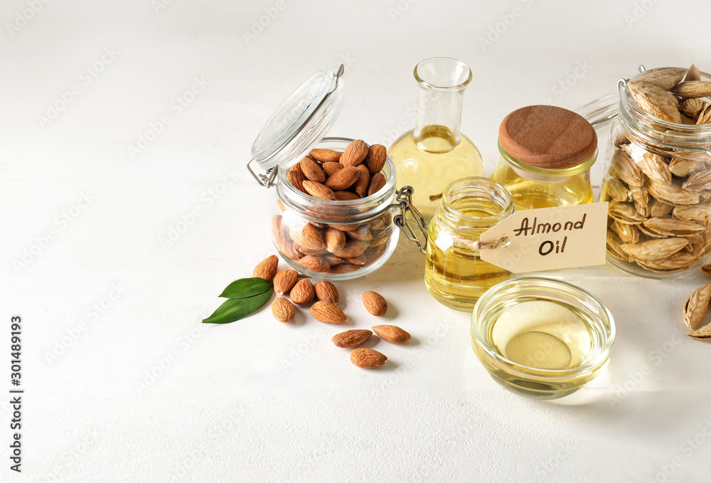 Tasty almond oil on white background Tasty almond oil on white background