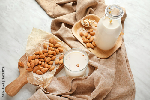 Tasty almond milk on white background