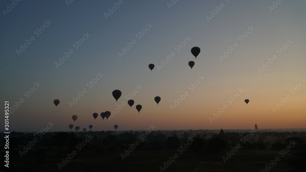 Many hot air balloons above Bagan in Myanmar with sunrise time.