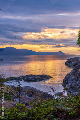 View of ocean sunset over mountains in beautiful British Columbia.