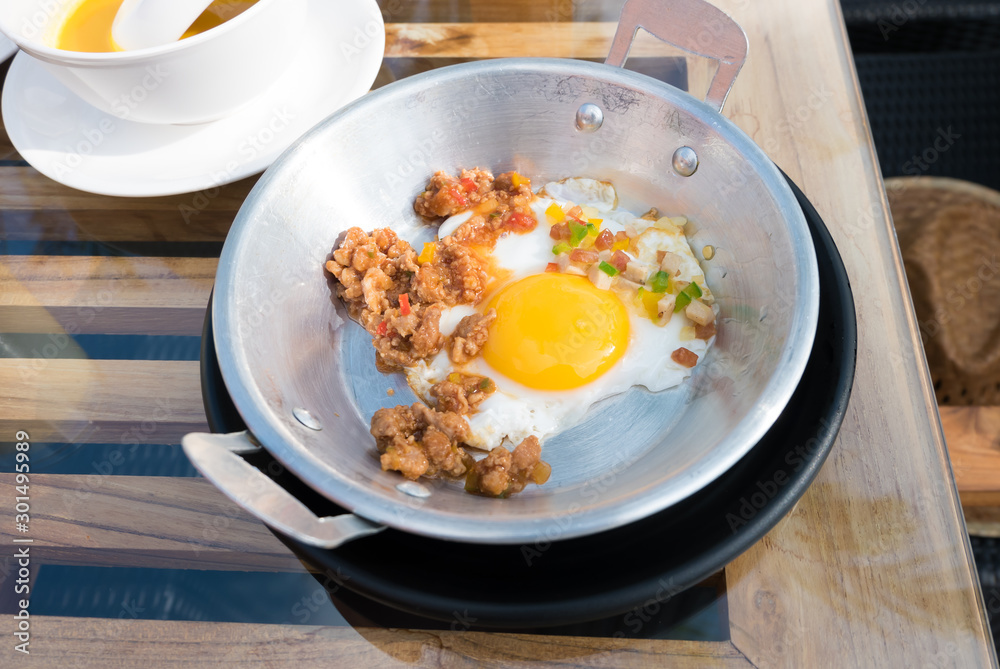 Vietnamese style fried egg in metal pan with bread and orange juice Vietnamese style fried egg in metal pan with bread and orange juice