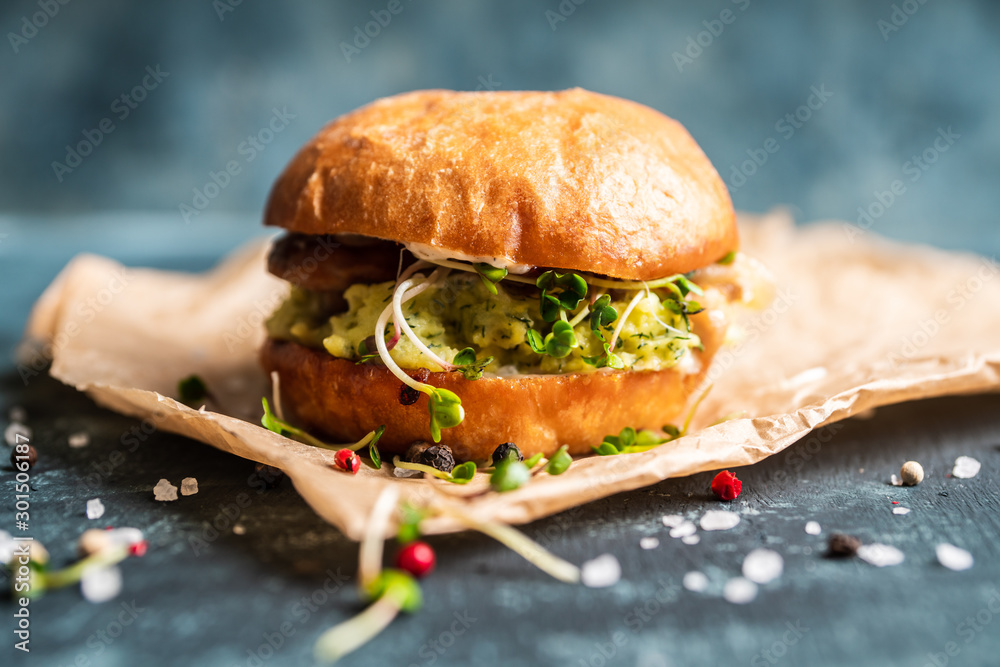 Fresh tasty burgers with roasted chicken, potato, micro greens and different herbs on the rustic background. Selective focus. Shallow depth of field. - obrazy, fototapety, plakaty 