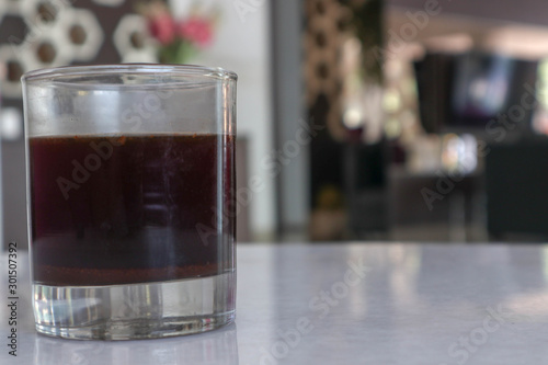old fashioned glass of black coffee in the hotel and cafe in the afternoon and evening - segelas kopi hitam di hotel dan cafe pada sore dan malam hari