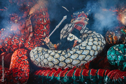 A Japanese samurai fighting against Yamata no Orochi (legendary 8-headed and 8-tailed Japanese dragon) in Kagura performance photo