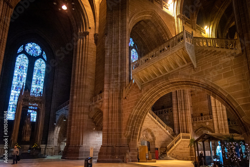 LIVERPOOL, ENGLAND, DECEMBER 27, 2018: People walking along the entrance hall of the Church of England Anglican Cathedral of the Diocese of Liverpool with a christmas tree aside during holidays.