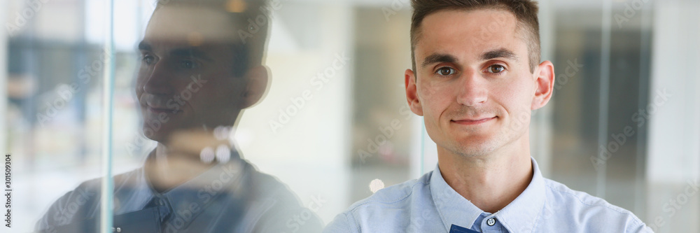 Fototapeta premium Handsome man in shirt and folder stand