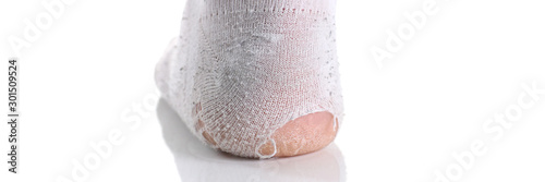 Ripped white sock on male leg isolated