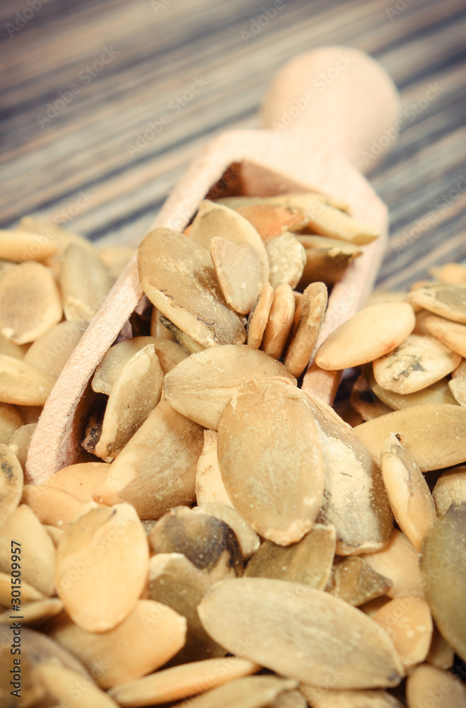Heap of pumpkin with spoon on board. Healthy food containing dietary fiber Heap of pumpkin with spoon on board. Healthy food containing dietary fiber