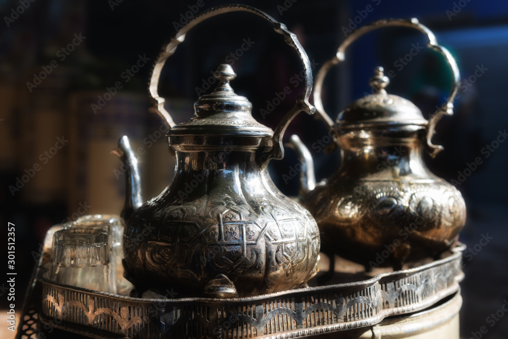 Traditional moroccan teapot with glasses in a tea tray. Traditional moroccan teapot with glasses in a tea tray.