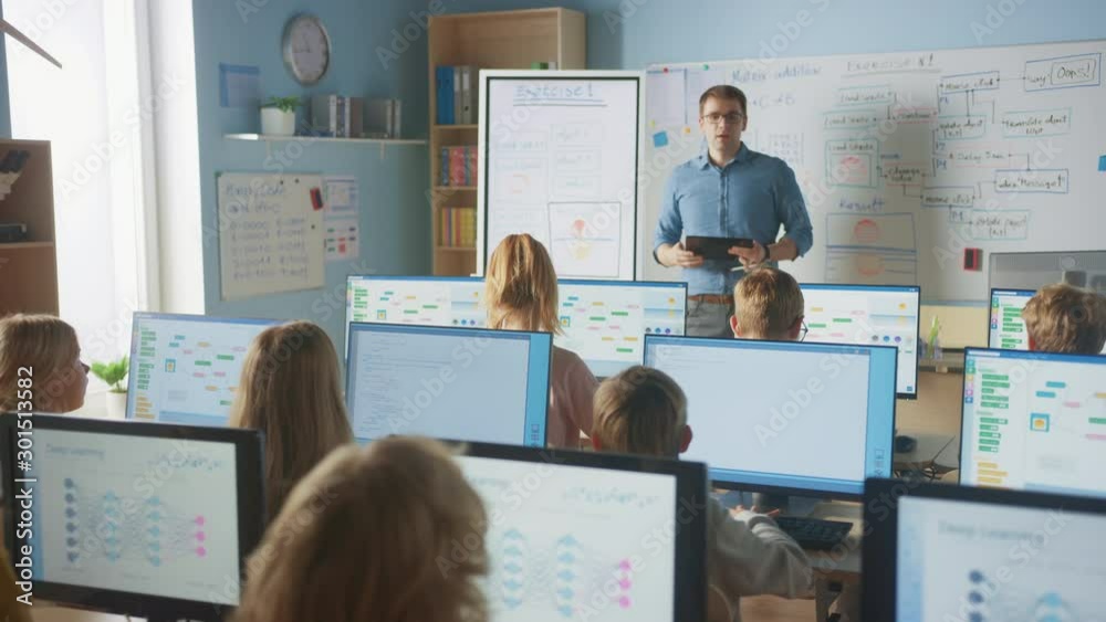 Elementary School Class: Teacher Uses Interactive Digital Whiteboard, Explains Lesson to Diverse Group of Smart Children. Kids getting Modern Education, Learn Computer Science, Software Programming