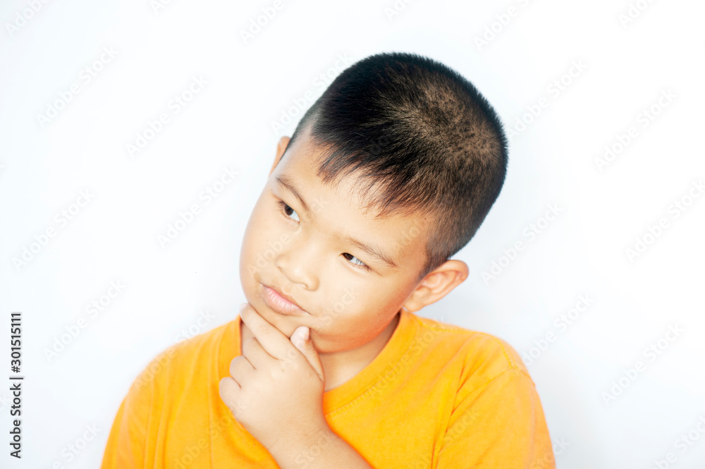Feelings Emotions and States of Mind of young asian boy thinking over white background. Half-length emotional portrait of boy wearing Orange shirt. Thoughtful concept.
