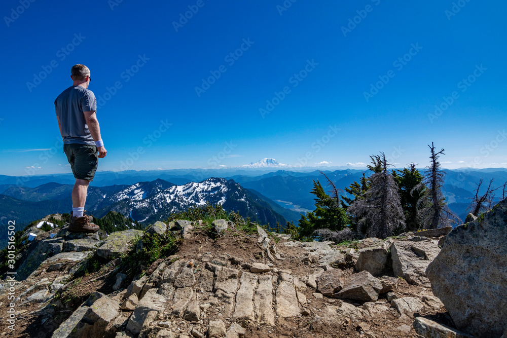 Adventurous man standing on top of a mountain. Adventurous man standing on top of a mountain.