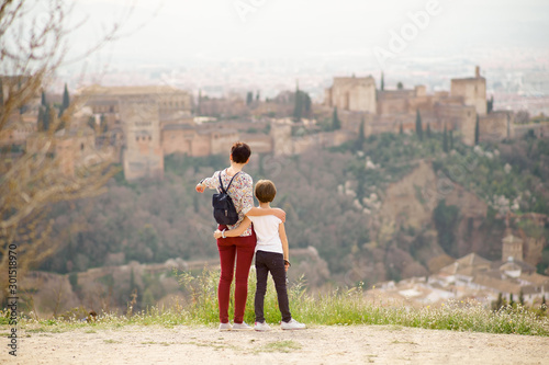 Mother and little daughter looking at the Alhambra