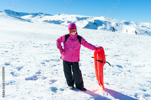 Little girl sledding at Sierra Nevada ski resort.