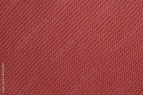 Knitted background of redwood color. Detailed diagonal knitting texture. Garter stitch pattern
