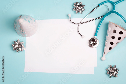 Photography Doctor's or nurse day greeting card with stethoscope and festive caps on blue background