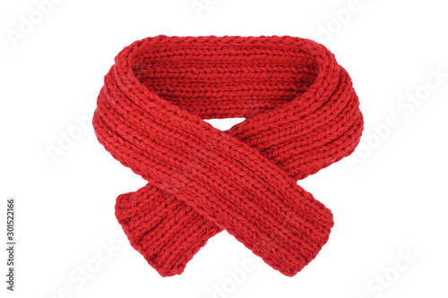 Small red knitted scarf isolated on a white background. Handmade woolen neckwear. Closeup. Copy space photo