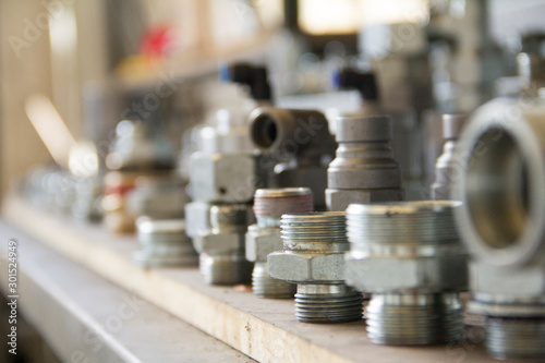 Metal bolts and nuts in a row background. Chromed screw bolts and nuts isolated. Steel bolts and nuts pattern. Set of Nuts and bolts. Tools for work