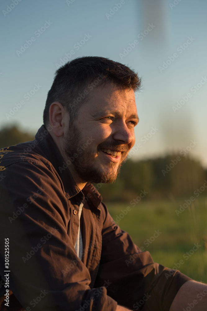 Handsome young man portrait. Intense look and eye-catching beauty. Fashionable hair and beard. The young man is wearing a brown shirt. Handsome young man portrait. Intense look and eye-catching beauty. Fashionable hair and beard. The young man is wearing a brown shirt.