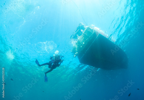 underwater landscape with diver and bottom of the boat