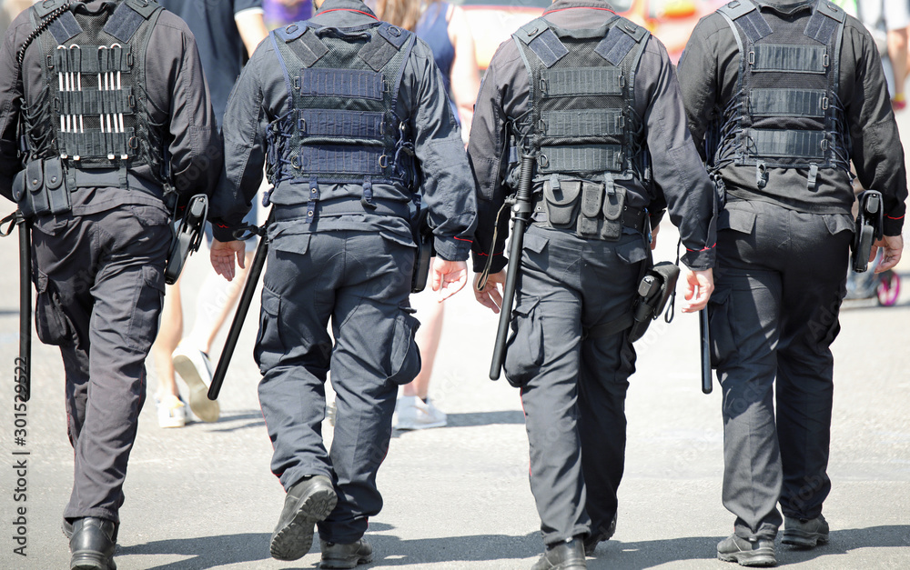 four cops patrolling the street four cops patrolling the street