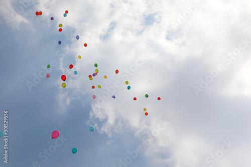 many ballons on the air and white clouds