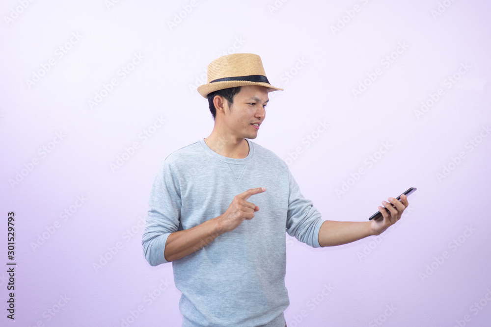 Happy asian man shopping with smart phone on pink background. Happy asian man shopping with smart phone on pink background.