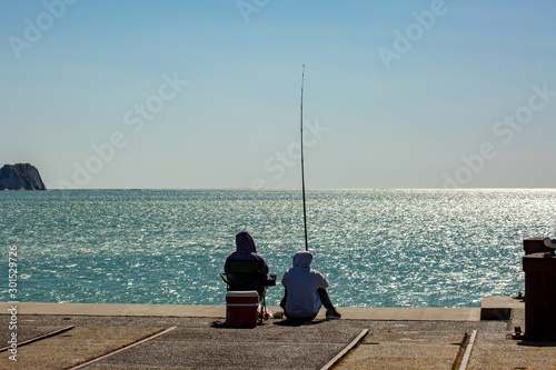 Unknown husband and wife spending the day fishing off the Tolaga Bay wharf