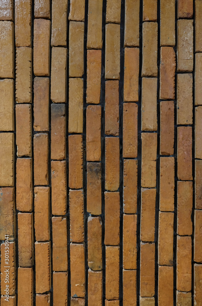 Close up old weathered vertical red brick wall high resolution, detailed red vintage texture background. Close up old weathered vertical red brick wall high resolution, detailed red vintage texture background.