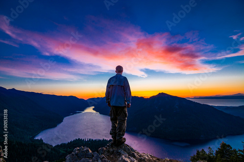 Adventurous man watching a sunset from a mountaintop. © Pelo Blanco Photo