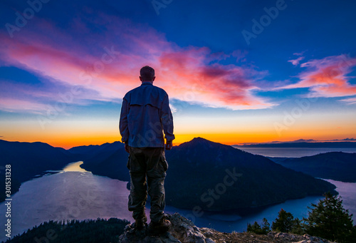 Adventurous man watching a sunset from a mountaintop. © Pelo Blanco Photo